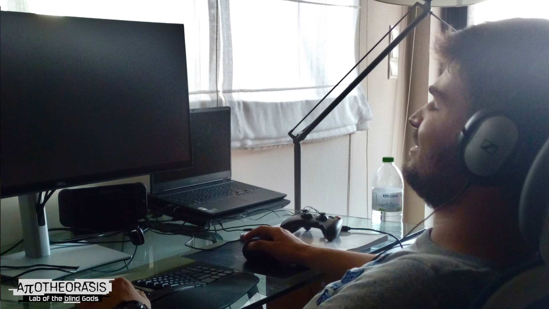 Apotheorasis - a man leans back, eyes shut while sitting at his computer
